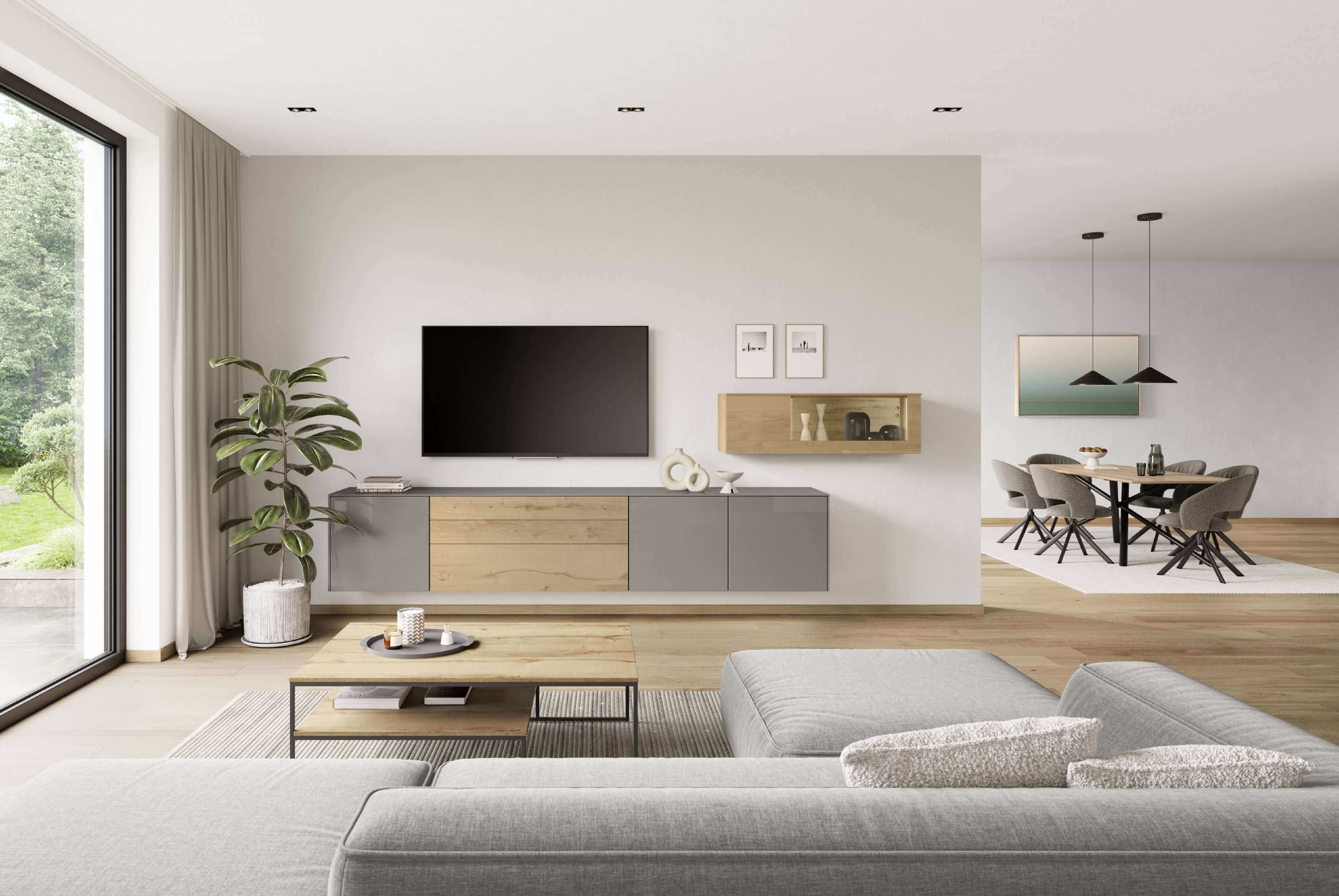Die moderne Wohnwand mit integriertem Stauraum verbindet warme Holztöne mit ruhigen grauen Fronten und schafft eine klare, zeitlose Optik.